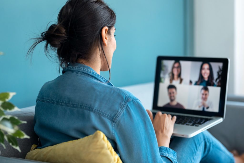 woman speaking on video call with diverse colleagues on online briefing