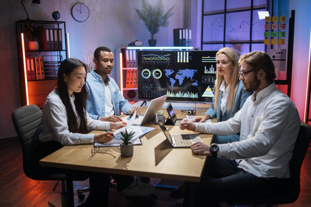Multiracial team of financiers using gadgets at office 1.jpg